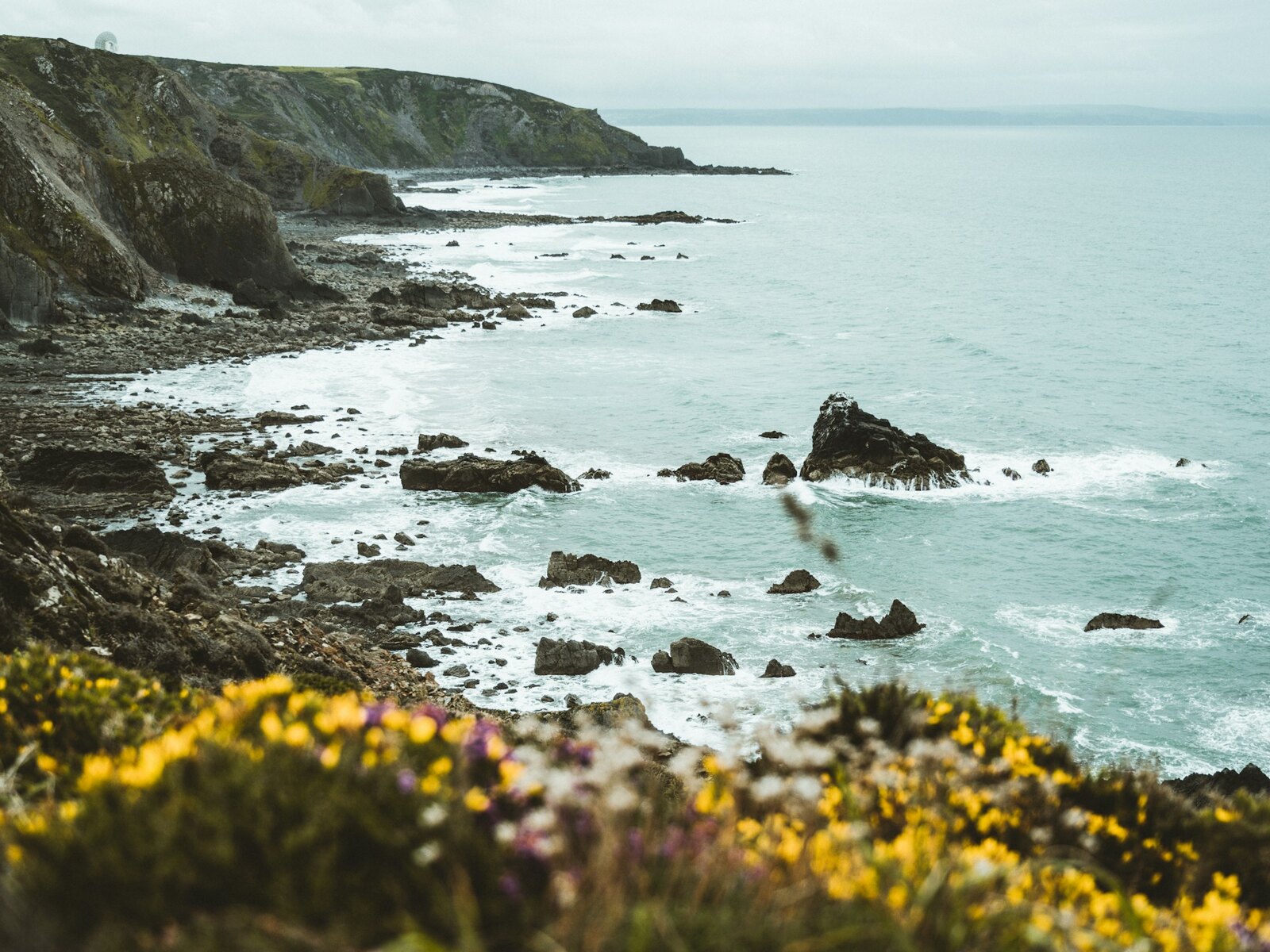 The rocky coast at St Agnes under a soft grey sky